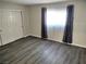 Bedroom with wood-look flooring, closet, and bright natural light from the window at 4368 Vornsand Dr, Las Vegas, NV 89115