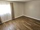 Bright bedroom features wood-look flooring and a window with sheer curtains at 4368 Vornsand Dr, Las Vegas, NV 89115