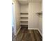 Walk-in closet features wood-look flooring and built-in shelving at 4368 Vornsand Dr, Las Vegas, NV 89115