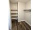 Walk-in closet features wood-look flooring and built-in shelving at 4368 Vornsand Dr, Las Vegas, NV 89115