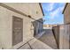 A side exterior view of a multi-Gathering home with metal security doors and gravel landscaping at 4368 Vornsand Dr, Las Vegas, NV 89115
