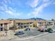 Apartment complex featuring covered balconies and desert landscaping, with mountain views in the distance at 4368 Vornsand Dr, Las Vegas, NV 89115