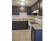 Kitchen features a double sink, white appliances, and dark cabinets at 4368 Vornsand Dr, Las Vegas, NV 89115