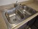 Kitchen featuring a stainless steel dual-basin sink with a chrome faucet at 4368 Vornsand Dr, Las Vegas, NV 89115