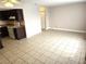 A living room featuring tile flooring that opens to the kitchen area at 4368 Vornsand Dr, Las Vegas, NV 89115