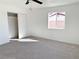 Bright bedroom with neutral carpet, a ceiling fan, and a closet at 4818 E Monroe Ave, Las Vegas, NV 89110
