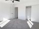 Clean and airy bedroom with a ceiling fan, a closet, and neutral carpet at 4818 E Monroe Ave, Las Vegas, NV 89110