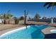 Inviting in-ground pool with clear blue water and a desert landscape in the backyard at 4818 E Monroe Ave, Las Vegas, NV 89110