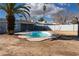 Backyard featuring a refreshing in-ground pool surrounded by desert landscaping and tall palm trees at 4818 E Monroe Ave, Las Vegas, NV 89110