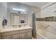 This bright bathroom features double sinks, great lighting, and a shower-tub combination at 4821 Black Bear Rd # 101, Las Vegas, NV 89149