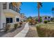 Pathway through a manicured community featuring well-maintained buildings with balconies and lush landscaping at 4821 Black Bear Rd # 101, Las Vegas, NV 89149