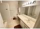 Bright bathroom featuring a large mirror, single sink vanity, toilet, and shower at 5751 E Hacienda Ave # 130, Las Vegas, NV 89122