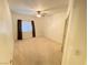 Bedroom with ceiling fan, neutral carpet, and natural light at 5751 E Hacienda Ave # 130, Las Vegas, NV 89122