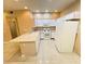 Spacious kitchen with an eat-in island, tile floor, and white appliances at 5751 E Hacienda Ave # 130, Las Vegas, NV 89122