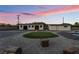 This backyard features a putting green, rock landscaping, and outbuildings at 616 Lacy Ln, Las Vegas, NV 89107
