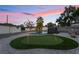 This backyard features a putting green, rock landscaping, pool and mature trees at 616 Lacy Ln, Las Vegas, NV 89107