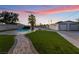 A sprawling backyard with a pool, mature trees, and artificial turf at 616 Lacy Ln, Las Vegas, NV 89107
