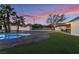 An open backyard design with artificial turf, a pool, and an extended covered patio at 616 Lacy Ln, Las Vegas, NV 89107