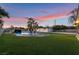Spacious backyard with a pool, lush artificial grass, and mature landscaping at 616 Lacy Ln, Las Vegas, NV 89107