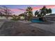 This backyard features a pool with rock features and an outdoor dining area at 616 Lacy Ln, Las Vegas, NV 89107