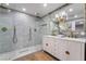 Modern bathroom with dual vanity, rainfall shower, gold fixtures, and stylish mirror at 616 Lacy Ln, Las Vegas, NV 89107