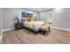 Bright bedroom with hardwood floors, neutral tones, and a view to the bathroom at 616 Lacy Ln, Las Vegas, NV 89107