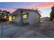 Home's side exterior showing an attached carport and detached garage with a spacious paved driveway at 616 Lacy Ln, Las Vegas, NV 89107