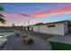 Exterior shot featuring multiple structures, an expansive gravel yard, and putting green at 616 Lacy Ln, Las Vegas, NV 89107