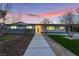 Charming single-story home featuring a tidy front lawn and walkway, set against a colorful twilight sky at 616 Lacy Ln, Las Vegas, NV 89107