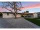 Well-maintained home exterior with covered patio, landscaped yard, and gravel groundcover at 616 Lacy Ln, Las Vegas, NV 89107