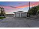 Detached two-car garage with spacious driveway and ample parking under a colorful sky at 616 Lacy Ln, Las Vegas, NV 89107