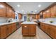 Well-lit kitchen featuring ample wood cabinetry, a center island, stainless steel appliances, and modern countertops at 616 Lacy Ln, Las Vegas, NV 89107