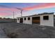This building features open garages with a concrete parking area at 616 Lacy Ln, Las Vegas, NV 89107