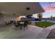 Covered patio with an outdoor seating area overlooking the backyard with a pool at 616 Lacy Ln, Las Vegas, NV 89107