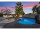 This backyard features a pool with rock features and palm trees at 616 Lacy Ln, Las Vegas, NV 89107