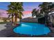 This backyard features a bright blue pool and waterfall feature at 616 Lacy Ln, Las Vegas, NV 89107