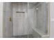 Modern glass shower with a built-in bench, hexagon tile floor, and rain shower head at 616 Lacy Ln, Las Vegas, NV 89107