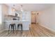 Stylish kitchen with quartz countertops, stainless steel appliances, modern pendant lights, and wood-look floors, perfect for entertaining at 629 Alecandro Daniel Ave, North Las Vegas, NV 89031