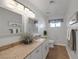 Bright bathroom with granite counters, neutral colors, and decorative mirrors and light fixtures at 645 Paloma Dr, Boulder City, NV 89005