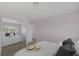 Bright bedroom with a white comforter, gray pillows, and reflected closet with mirrored sliding doors at 645 Paloma Dr, Boulder City, NV 89005