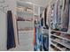 Organized walk-in closet with shelves, drawers, and hanging racks filled with clothing and shoes at 645 Paloma Dr, Boulder City, NV 89005