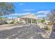 Spacious backyard featuring desert landscaping, a covered patio, mature trees, and ample space for customization at 6710 Pyracantha Glen Ct, Las Vegas, NV 89131