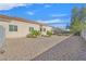 View of the backyard, showcasing low-maintenance desert landscaping, and rear exterior of the home at 6710 Pyracantha Glen Ct, Las Vegas, NV 89131
