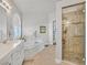Elegant bathroom featuring a soaking tub, glass enclosed shower, and dual sink vanity at 6710 Pyracantha Glen Ct, Las Vegas, NV 89131