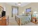 Cozy bedroom featuring a decorative bed frame, carpeted flooring, and ample natural light at 6710 Pyracantha Glen Ct, Las Vegas, NV 89131