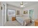 Bedroom with a ceiling fan, carpeted floor, sliding closet door, and attached bathroom at 6710 Pyracantha Glen Ct, Las Vegas, NV 89131