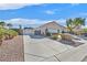 Exterior shot of the home's long driveway with desert landscaping and mature trees at 6710 Pyracantha Glen Ct, Las Vegas, NV 89131