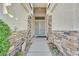 Inviting entryway with stone accents and a secure, decorative screen door at 6710 Pyracantha Glen Ct, Las Vegas, NV 89131