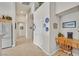 Bright hallway featuring tiled flooring, multiple doors, and a built-in desk area at 6710 Pyracantha Glen Ct, Las Vegas, NV 89131