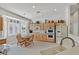 Bright kitchen features wood cabinets, tile floors, and a cozy breakfast nook with natural light at 6710 Pyracantha Glen Ct, Las Vegas, NV 89131